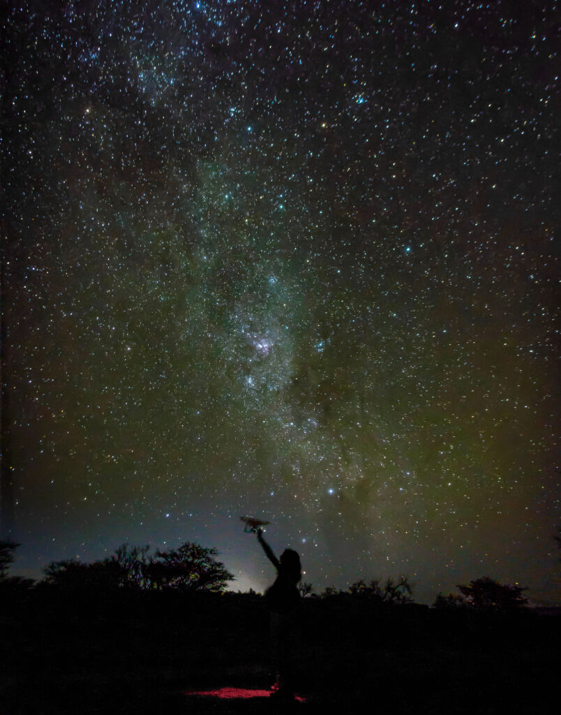 Milky Way galaxy in Namibian night with young researcher